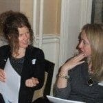 Dec2011JanFeb2012 180 Two women discussing work-life balance at a table.