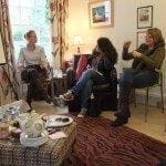 A group of people working at a table in a living room, finding the right work-life balance.