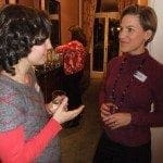 Two working women discussing their work-life balance at an event.