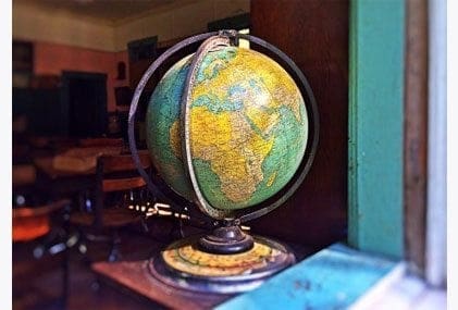 A career-oriented mum finding work-life balance with a globe sitting on a table in front of a window. A career-oriented mum finding work-life balance with a globe sitting on a table in front of a window.