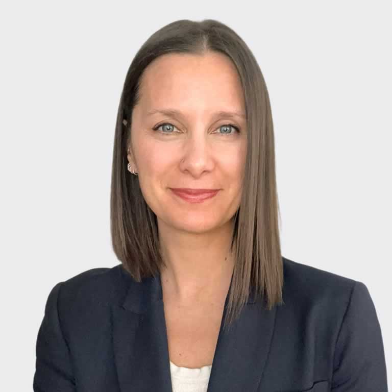 A woman with shoulder-length brown hair wearing a dark blazer, embodying the weight of maternal responsibility.