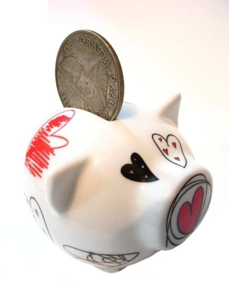 A piggy bank with a coin and hearts on it, symbolizing financial stability and love. A piggy bank with a coin and hearts on it, symbolizing financial stability and love.
