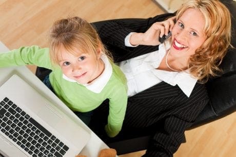A woman and a child working at a desk.