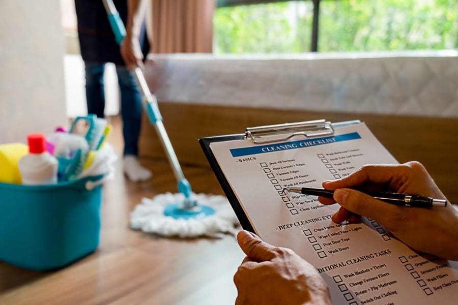 A person holding a clipboard with a checklist on it, starting a cleaning business.